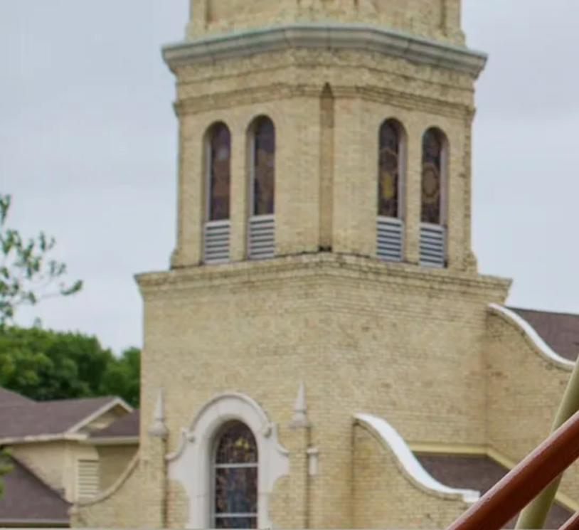 A church with a clock tower and stained glass windows
