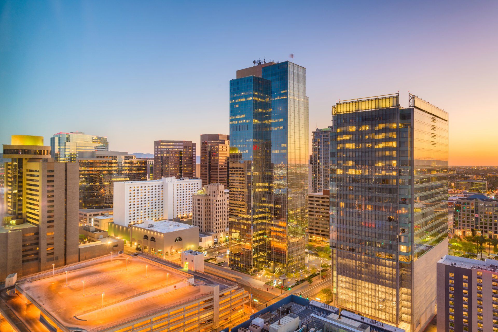 A skyline view of Phoenix shows skyscrapers against the sunset. Digital marketing in Phoenix is key!