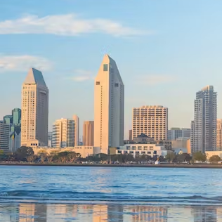 A city skyline with a large body of water in the foreground.