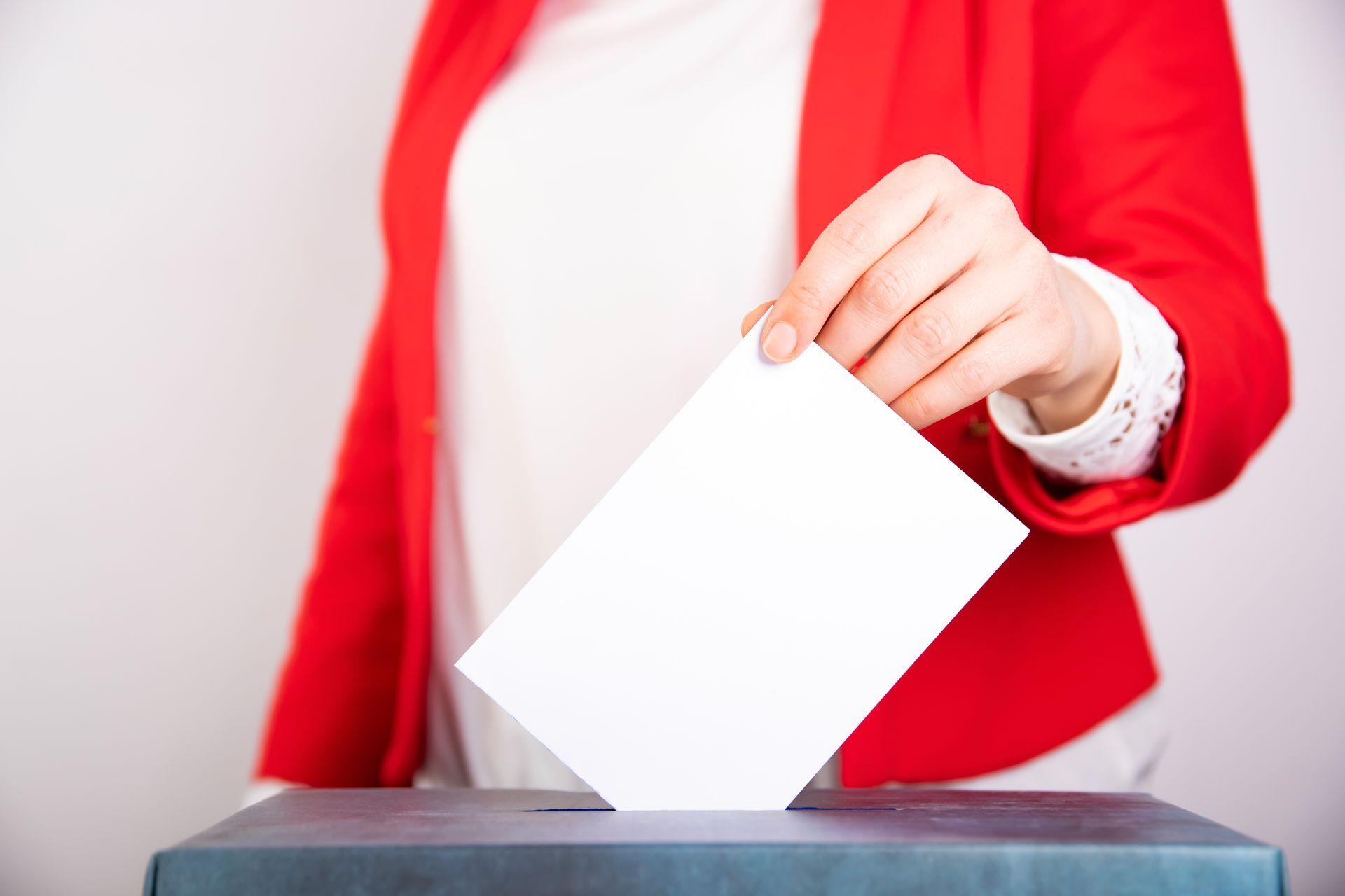 Woman ina red vest voting