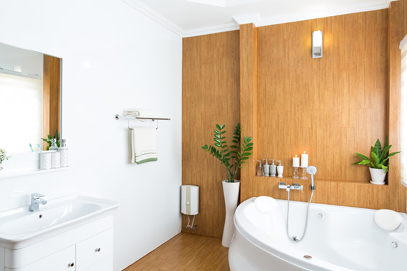 Bright white bathroom with wood accent wall, bathtub, sink, mirror, and potted plants.