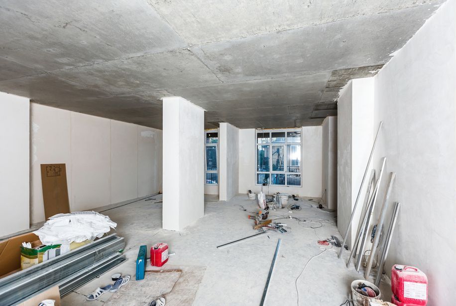 A large empty room with a ceiling that is being remodeled.