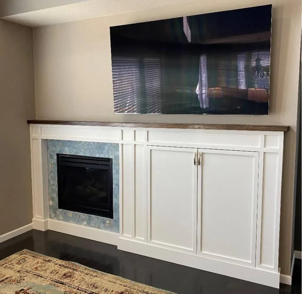 A living room with a fireplace and a flat screen tv