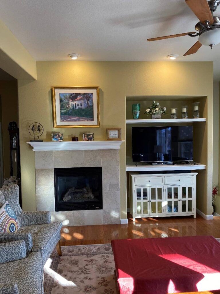 A living room with a fireplace and a flat screen tv