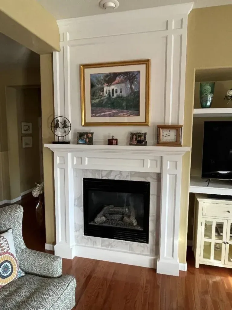 A living room with a fireplace and a television
