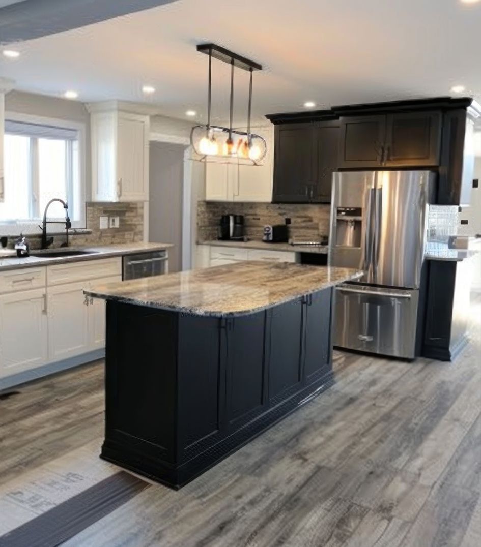 A kitchen with a large island and stainless steel appliances