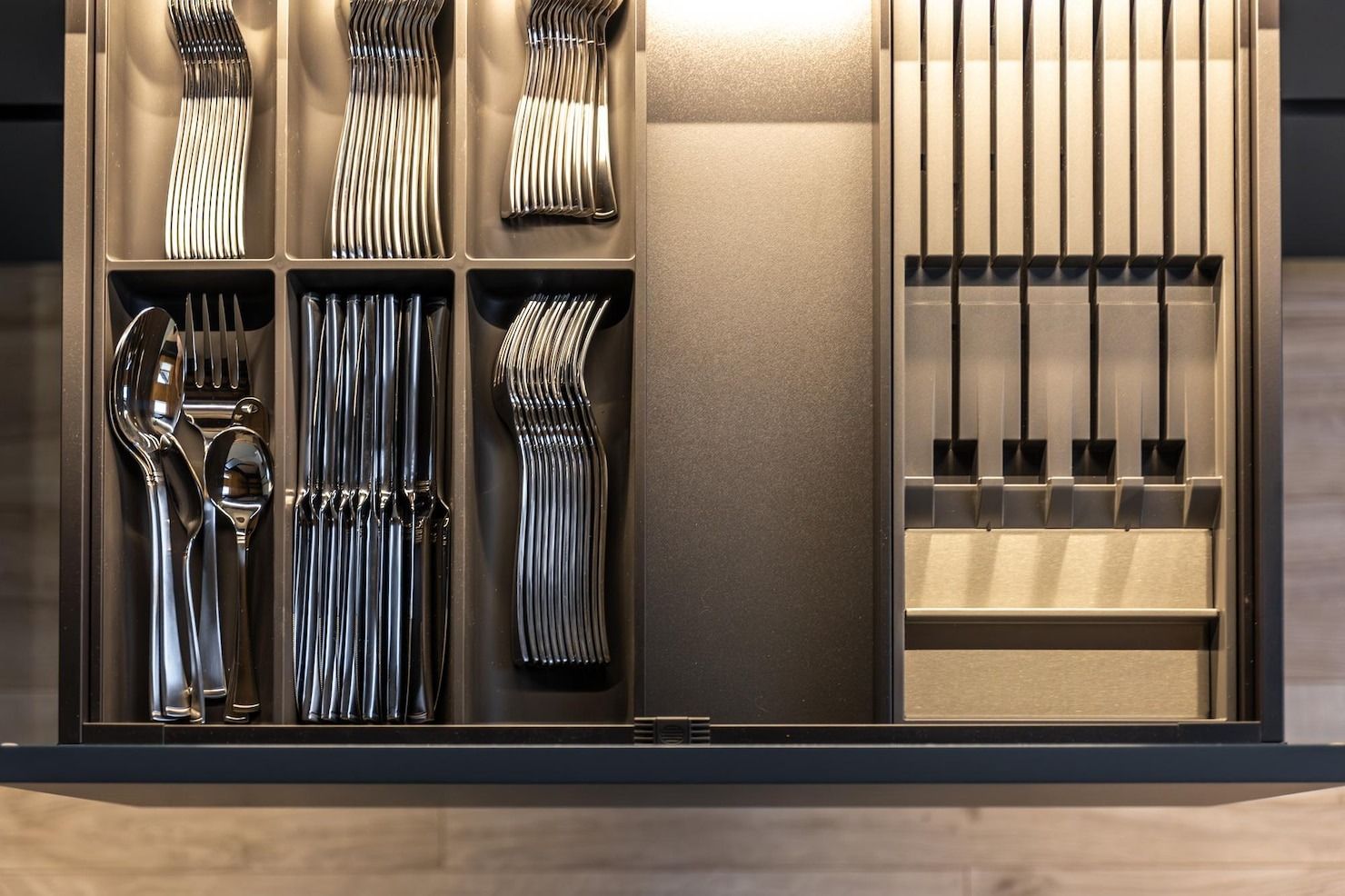 Modern open wardrobe with neatly arranged clothes, hangers, and shelves in a warm, minimalist closet.