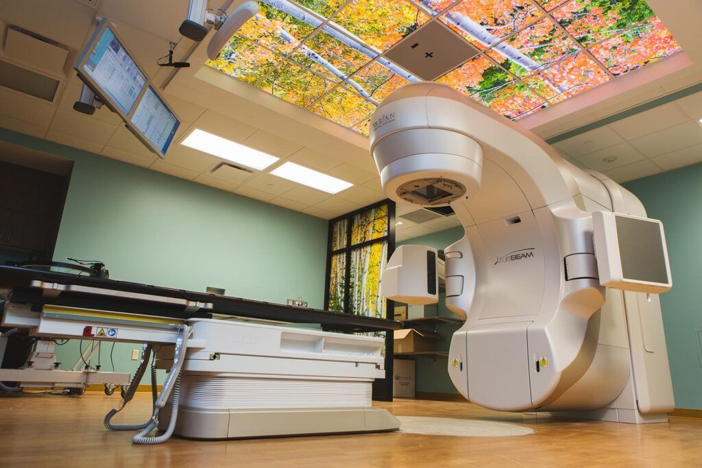 A large white machine is sitting in a room with a colorful ceiling.