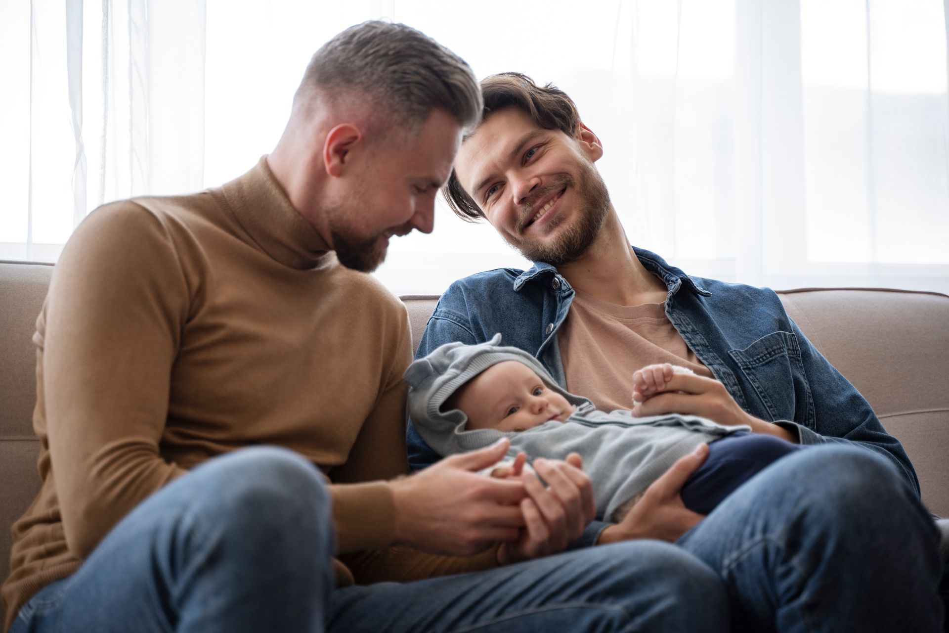 Happy gay couple with child conceived through surrogacy