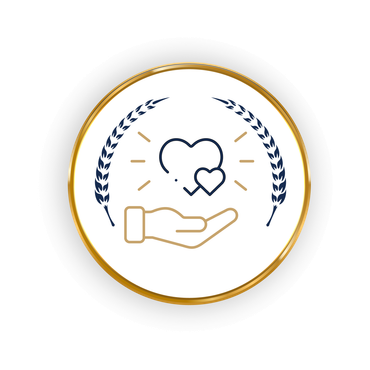 Hand holding two hearts with gold trim and wheat.