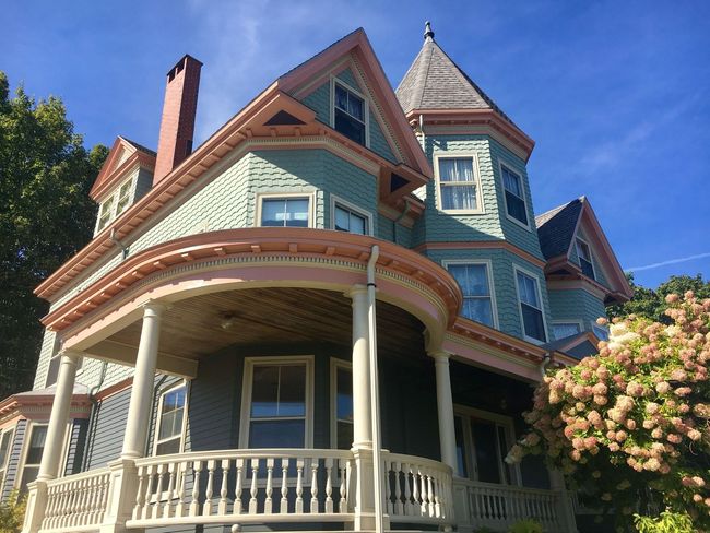 An upward looking view of a green and pink house
