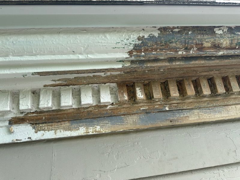 A bannister that has half of its paint removed