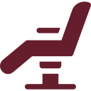 A red icon of a tattoo chair on a white background.