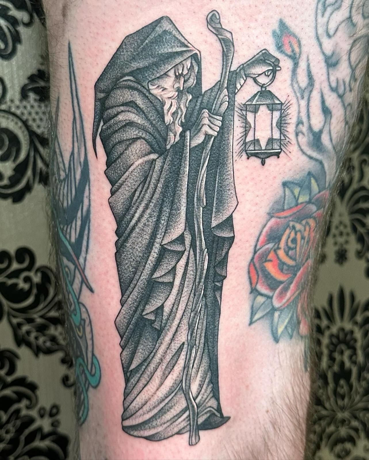 A tattoo of a grim reaper holding a lantern