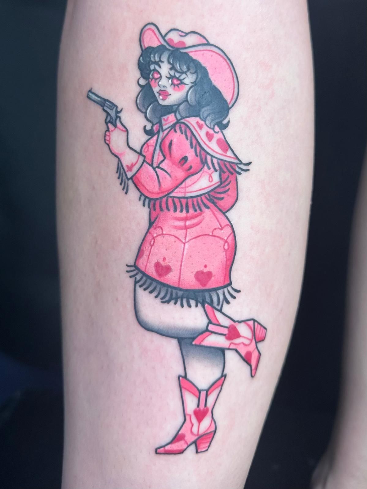 Tattoo of girl holding a gun
