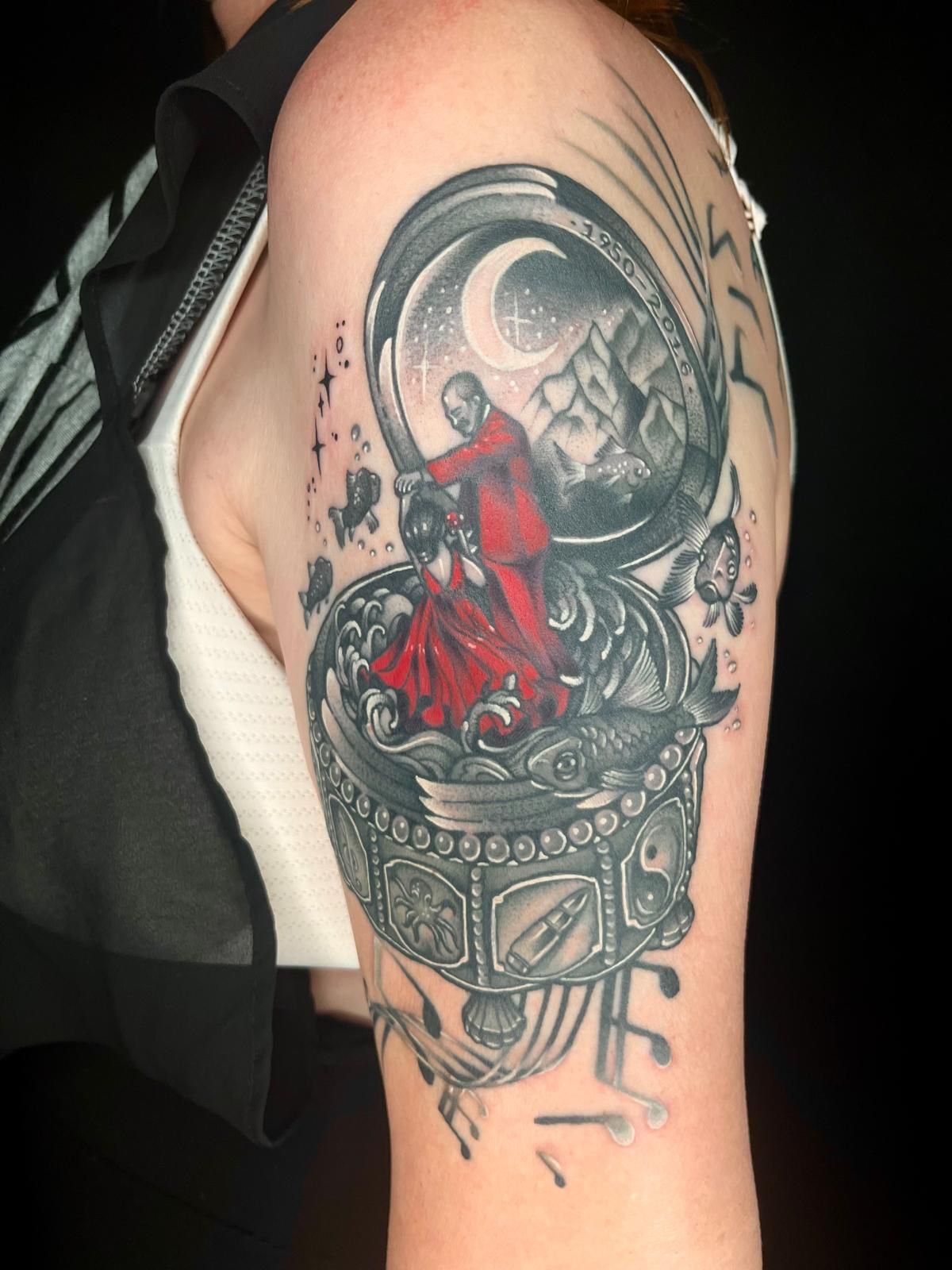 A woman has a tattoo of a man in a red robe on her arm