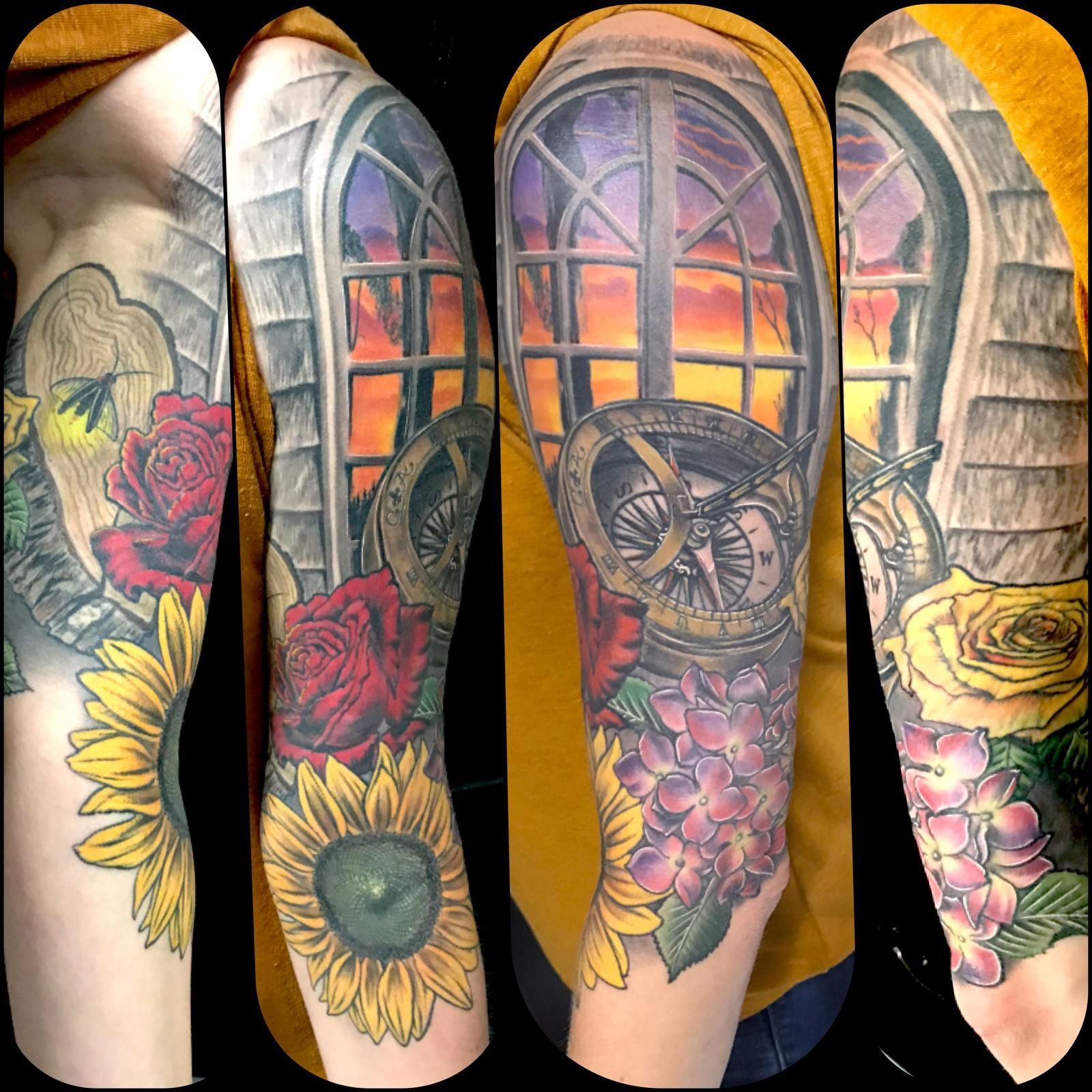 A tattoo of sunflowers and roses with a compass