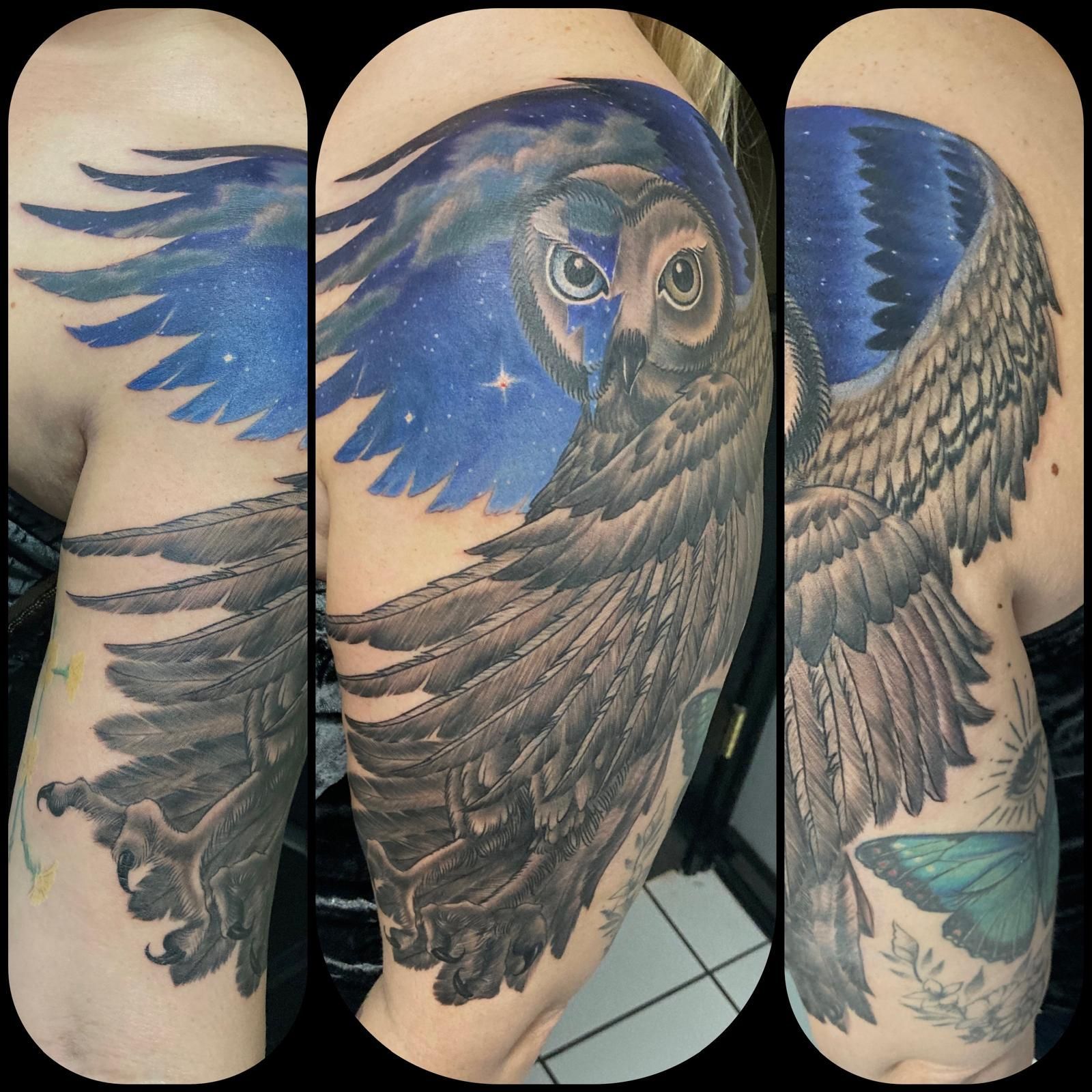 A person has a tattoo of an owl on their arm