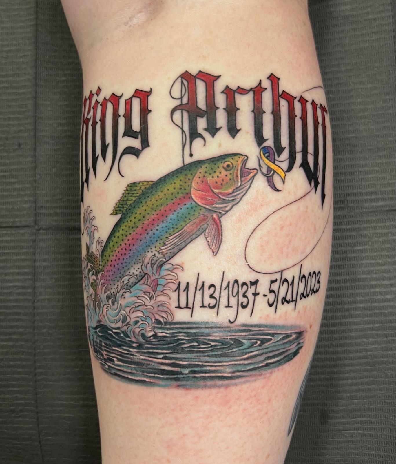 A tattoo of a rainbow trout jumping out of the water