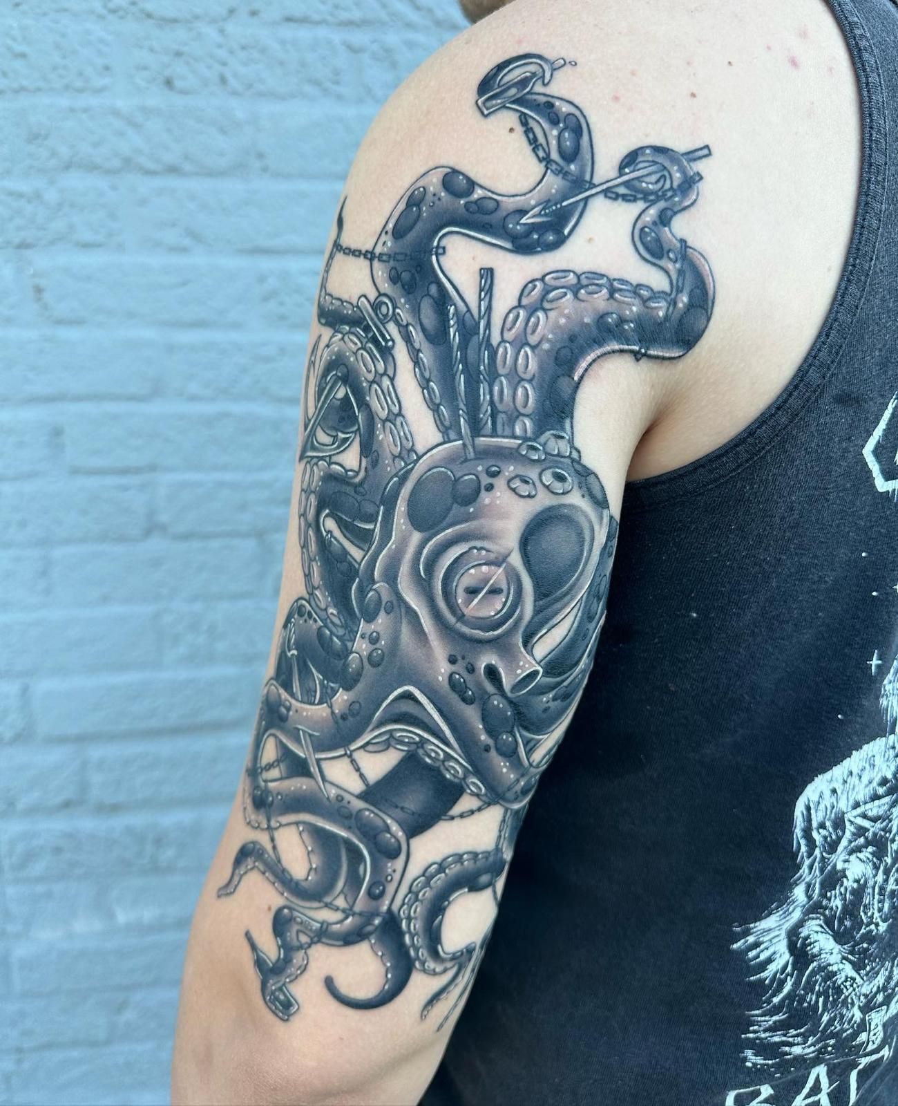 A man has an octopus tattoo on his arm