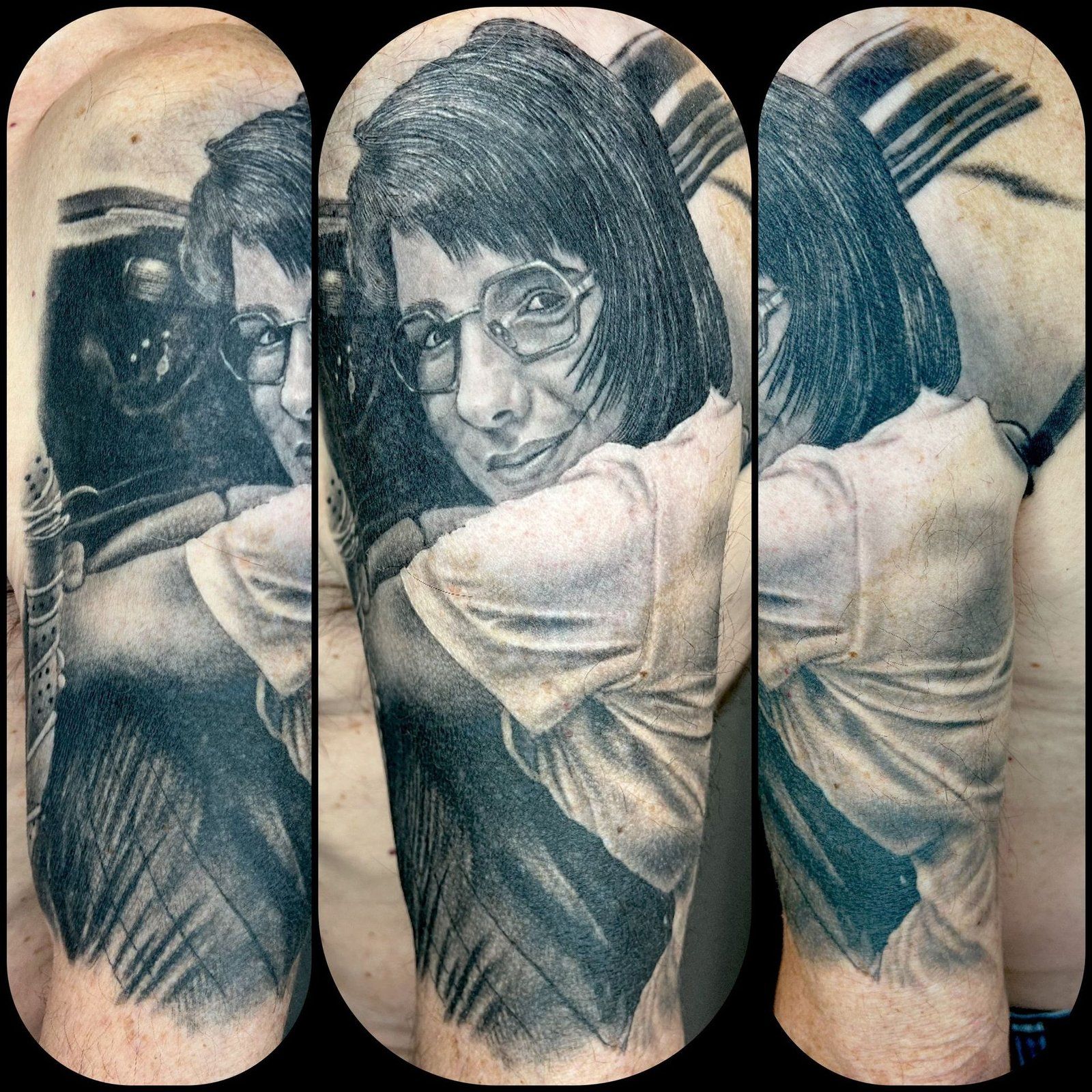 A black and white tattoo of a woman hugging a man