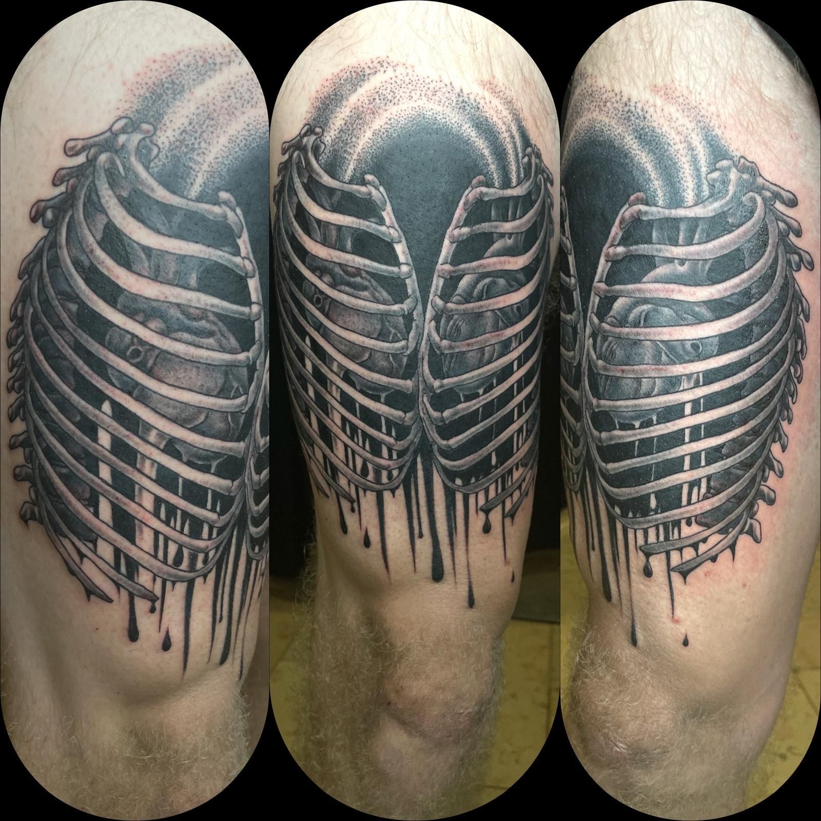 A man has a tattoo of ribs on his leg