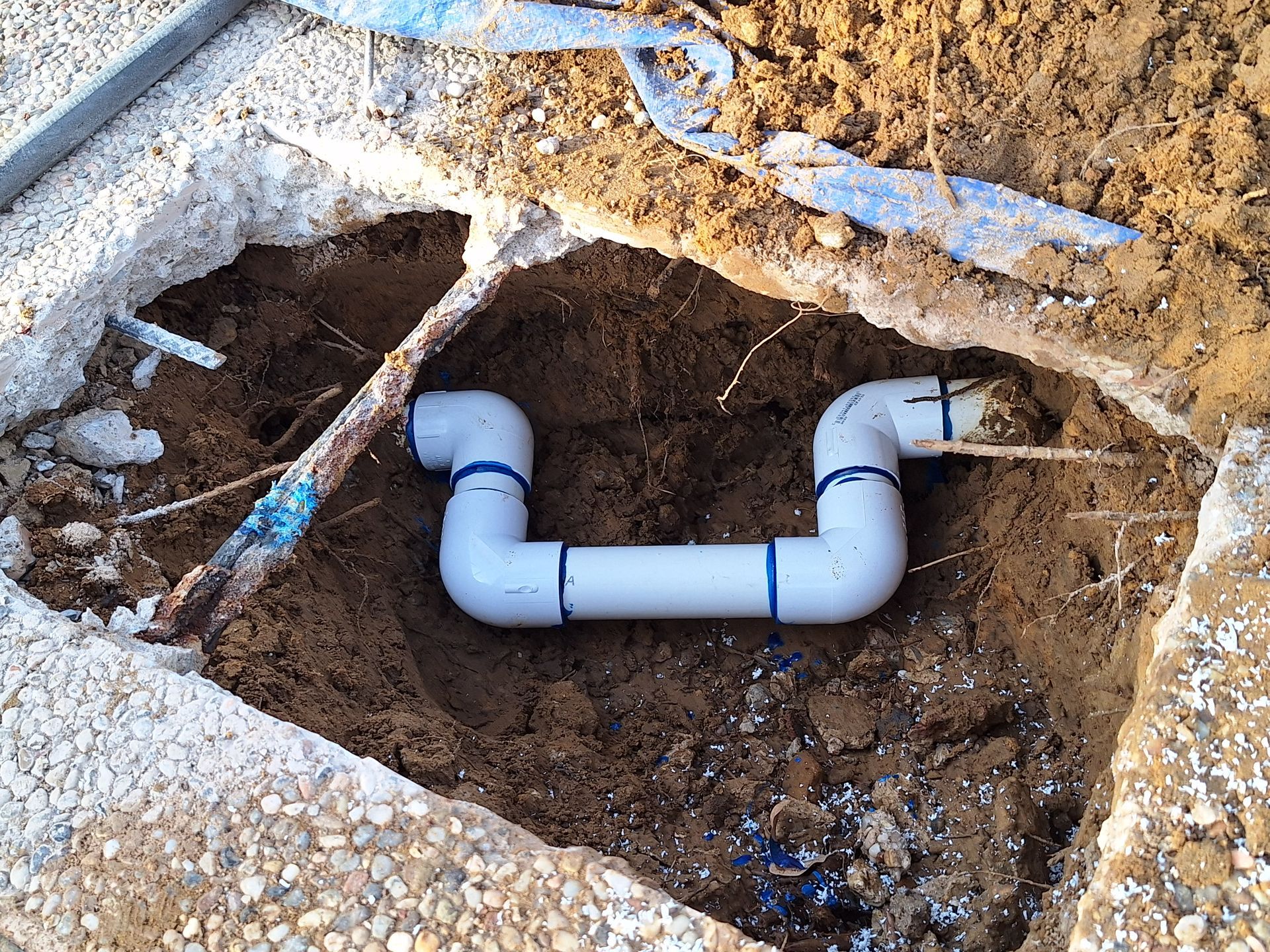 A pool plumbing repair for a pool leak under the concrete deck.