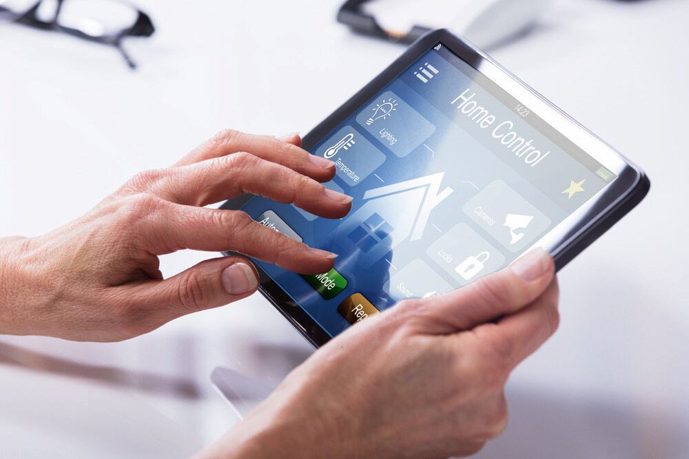 A Person is Using a Tablet With a Home Control App on It — Russell Taber Electrical & Solar in Lake Albert, NSW 
