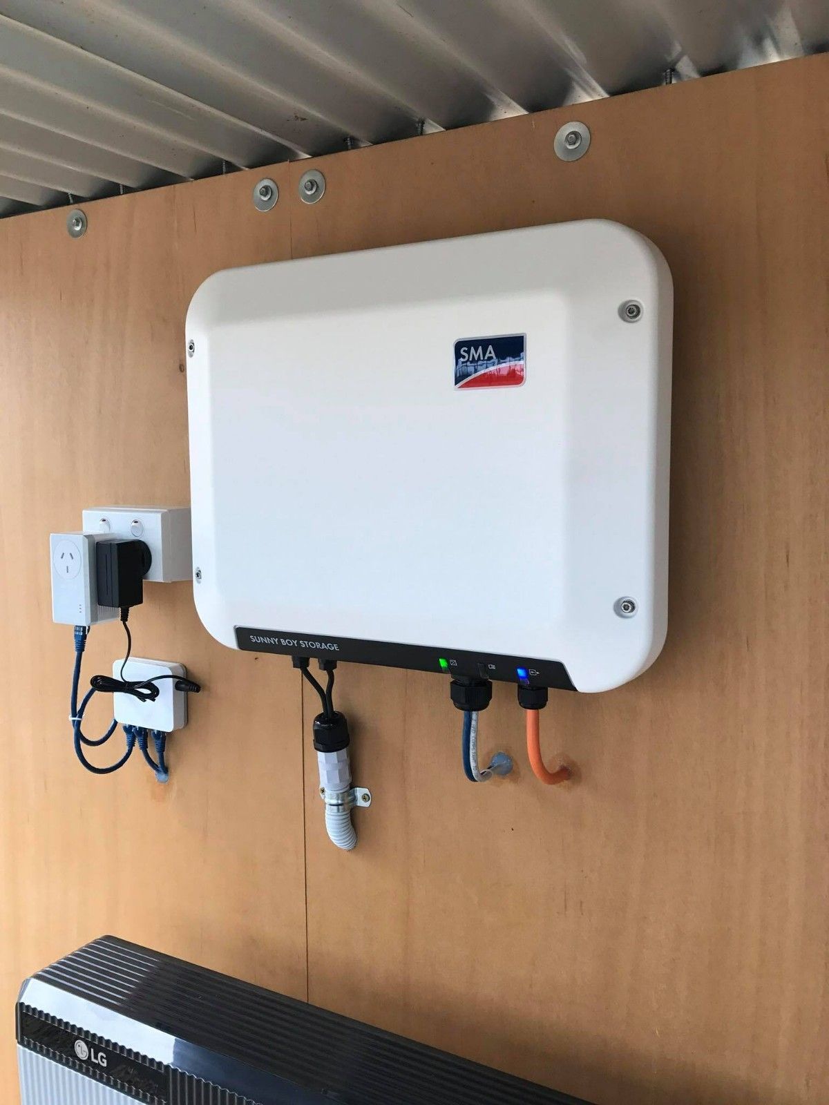 Solar Inverter and Battery System Mounted on a Wooden Wall — Russell Taber Electrical & Solar in Lake Albert, NSW