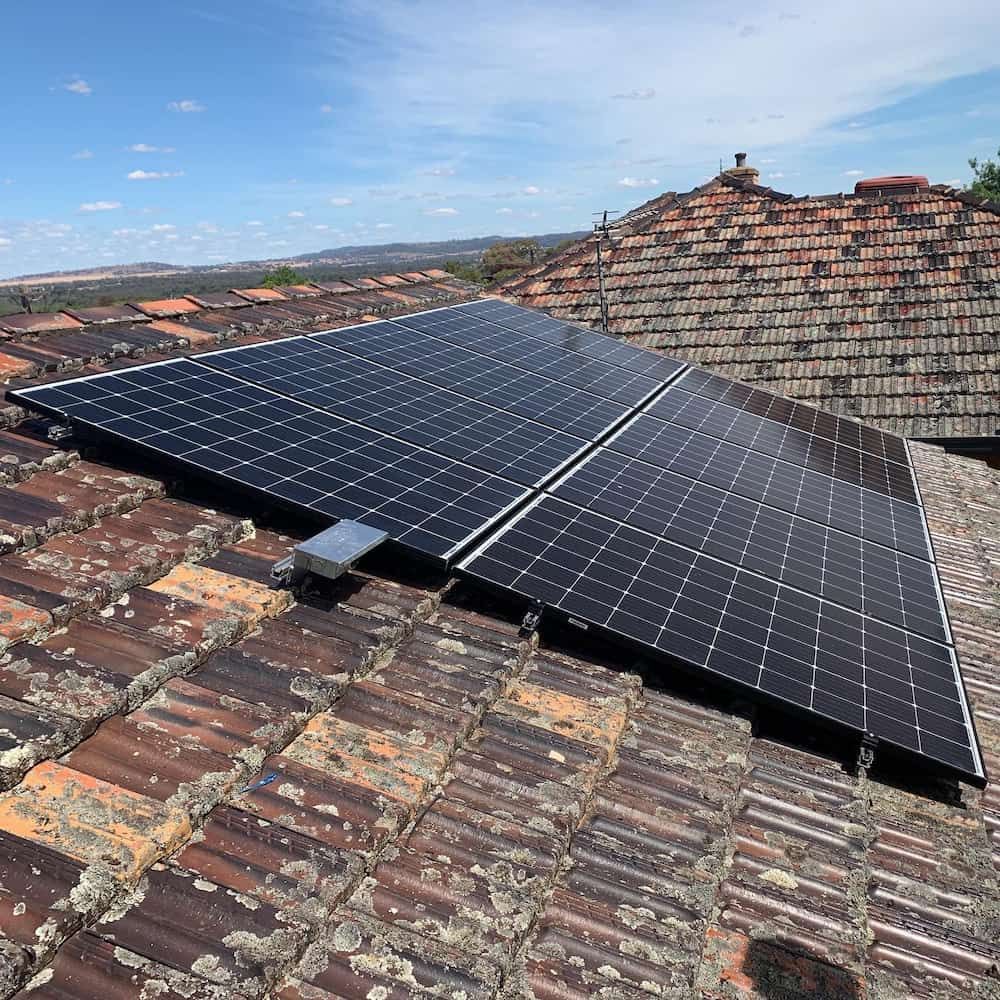A Row of Solar Panels Sitting on Top of a Tiled Roof — Russell Taber Electrical & Solar in Lake Albert, NSW