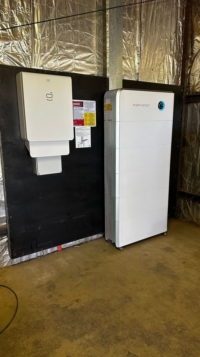 A Solar Battery is Mounted on the Side of a Wall — Russell Taber Electrical & Solar in Lake Albert, NSW 
