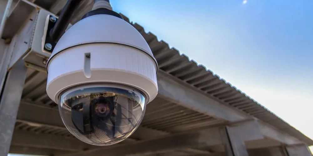 A Security Camera is Hanging From the Roof of a Building — Russell Taber Electrical & Solar in Lake Albert, NSW 
