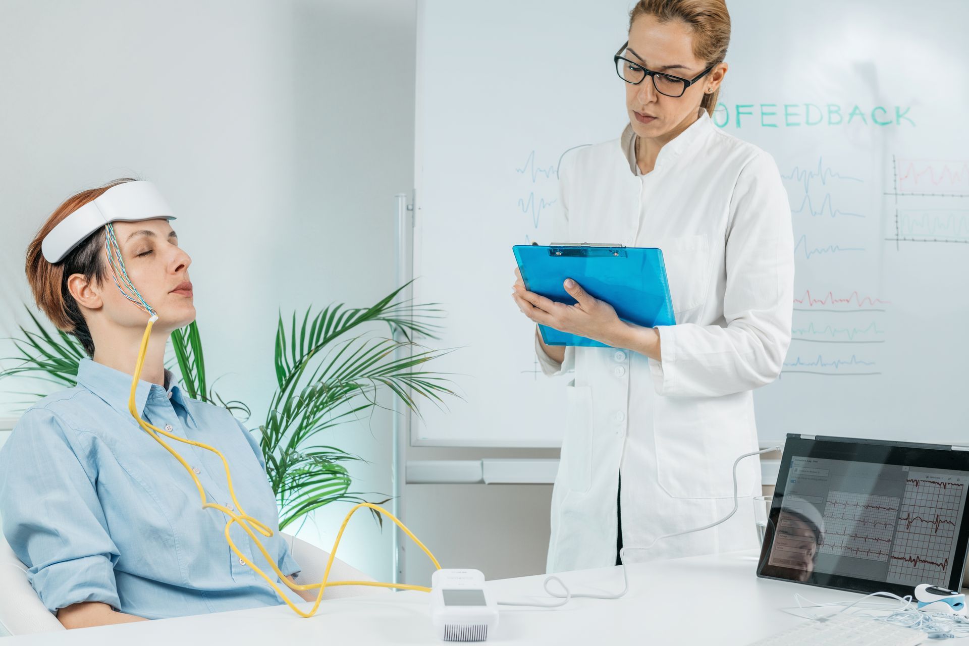 Clinician reviewing a patient’s brain scan during a monitoring session in a medical office
