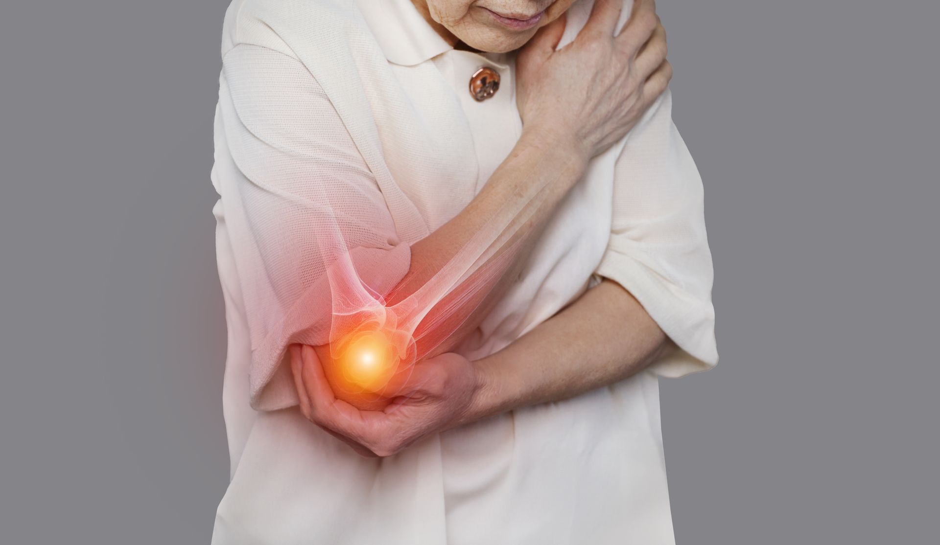 Person holding an elbow with glowing red pain area, suggesting joint pain or injury