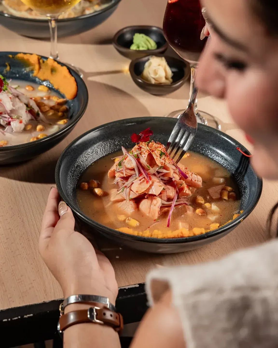 Guest enjoying a ceviche-style Nikkei dish at Enkai in Panama City.