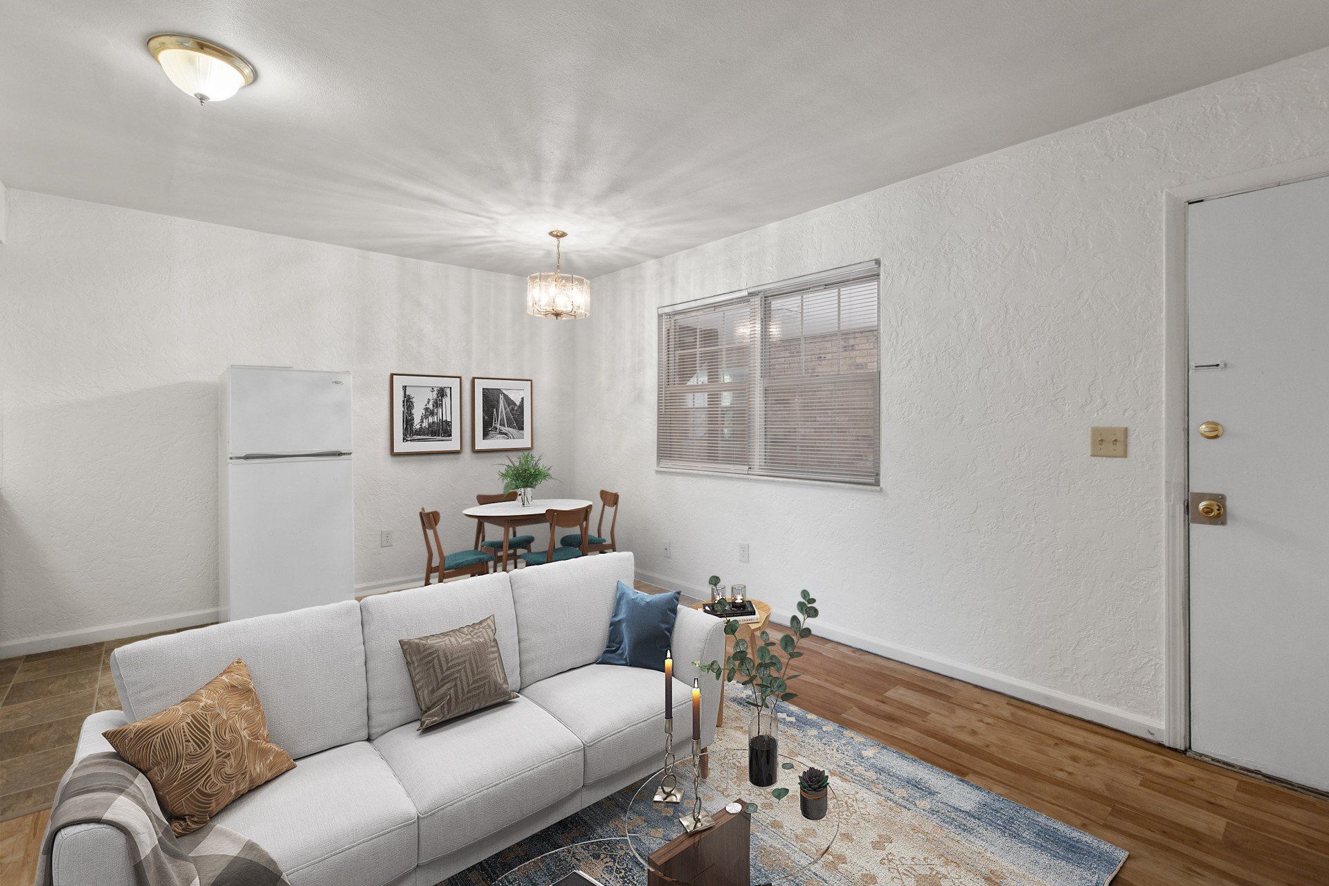 Updated living room with hardwood floor and window; and sofa, rug, and dining table are for example only.