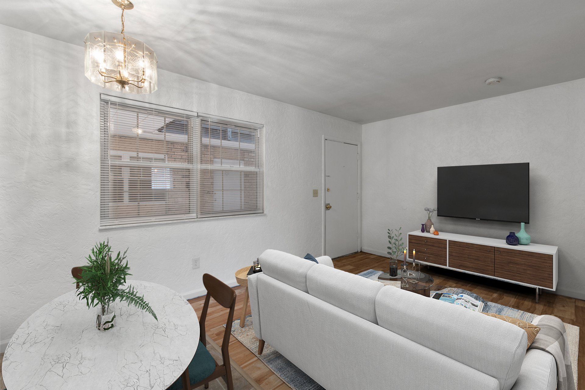 Updated living room with hardwood floor and window; and sofa, tv stand and dining table are for example only.