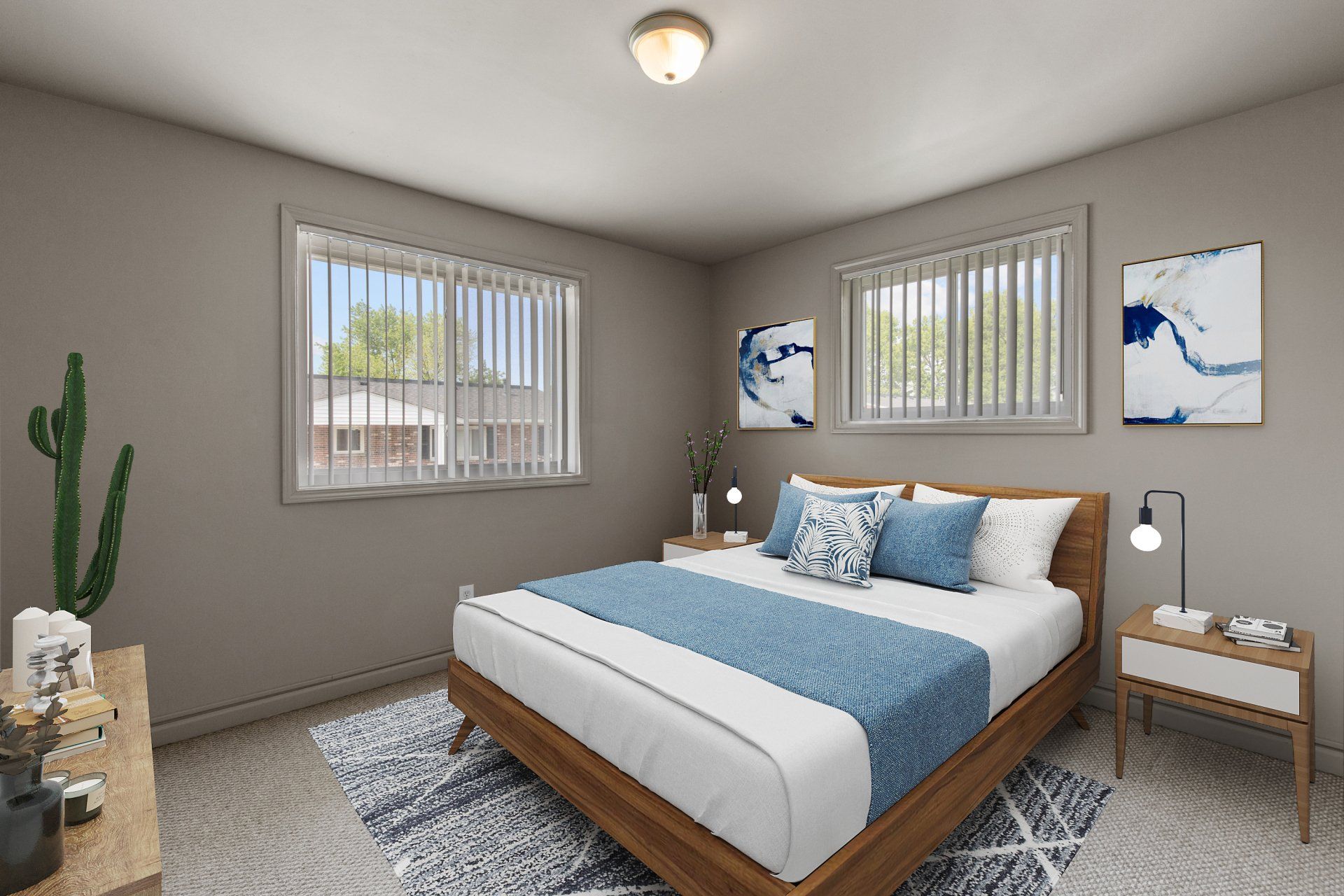 Teson Garden Apartments bedroom with two windows and bed and rug - furniture for example purposes only.