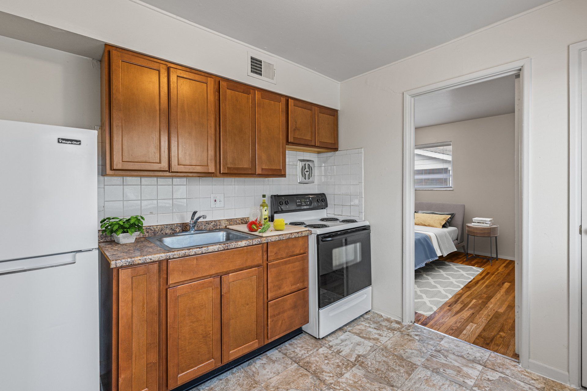 Charbonier Apartments kitchen with light wooden cabinets.