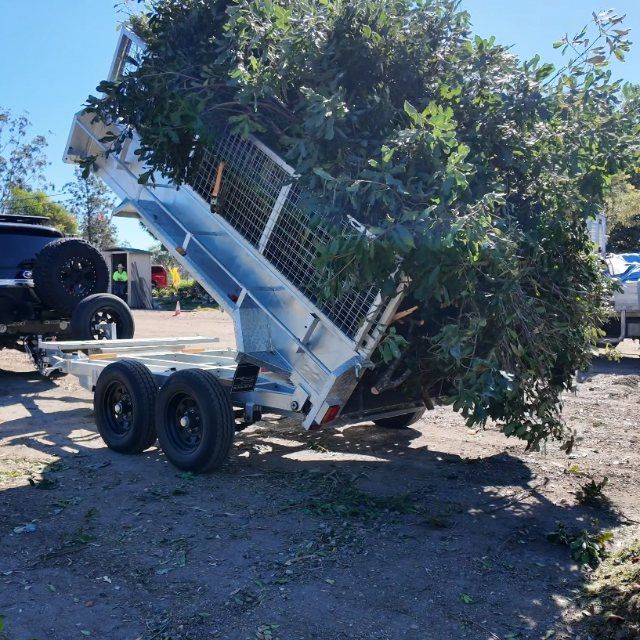 TrailerMates hydraulic tipper trailer tipping a load of green waste