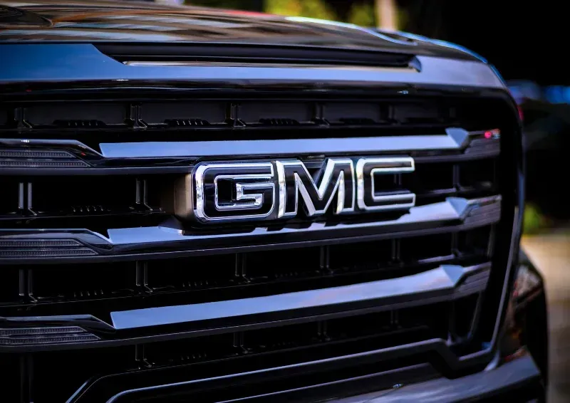 Close-up of a black GMC truck grille with chrome logo