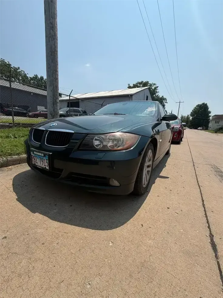BMW dealership exterior with several black cars parked in front