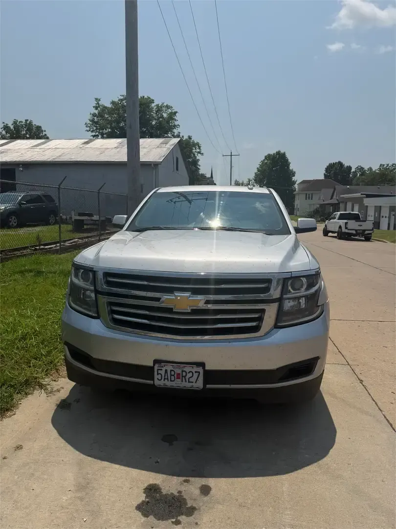 Black Chevrolet SUV parked at a Chevrolet dealership storefront