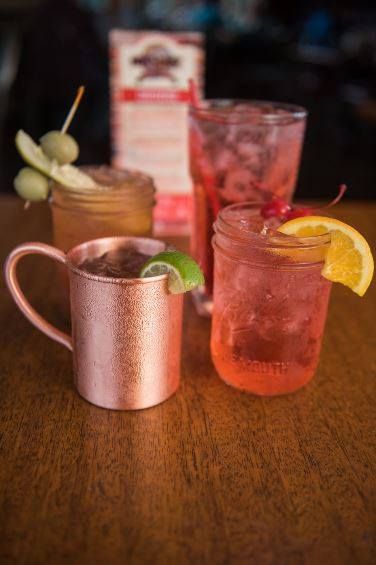 A table topped with four different types of drinks.