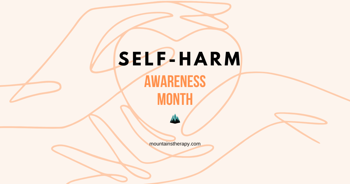 Two hands holding a heart for self-harm awareness.