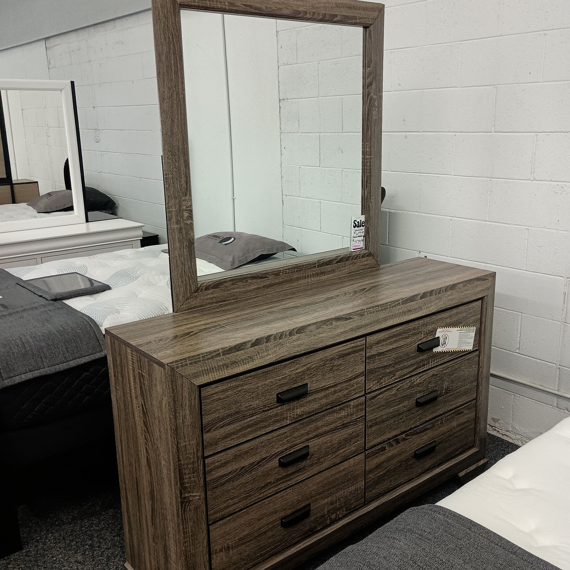 Wooden dresser with attached mirror, six drawers, and a gray textured finish.