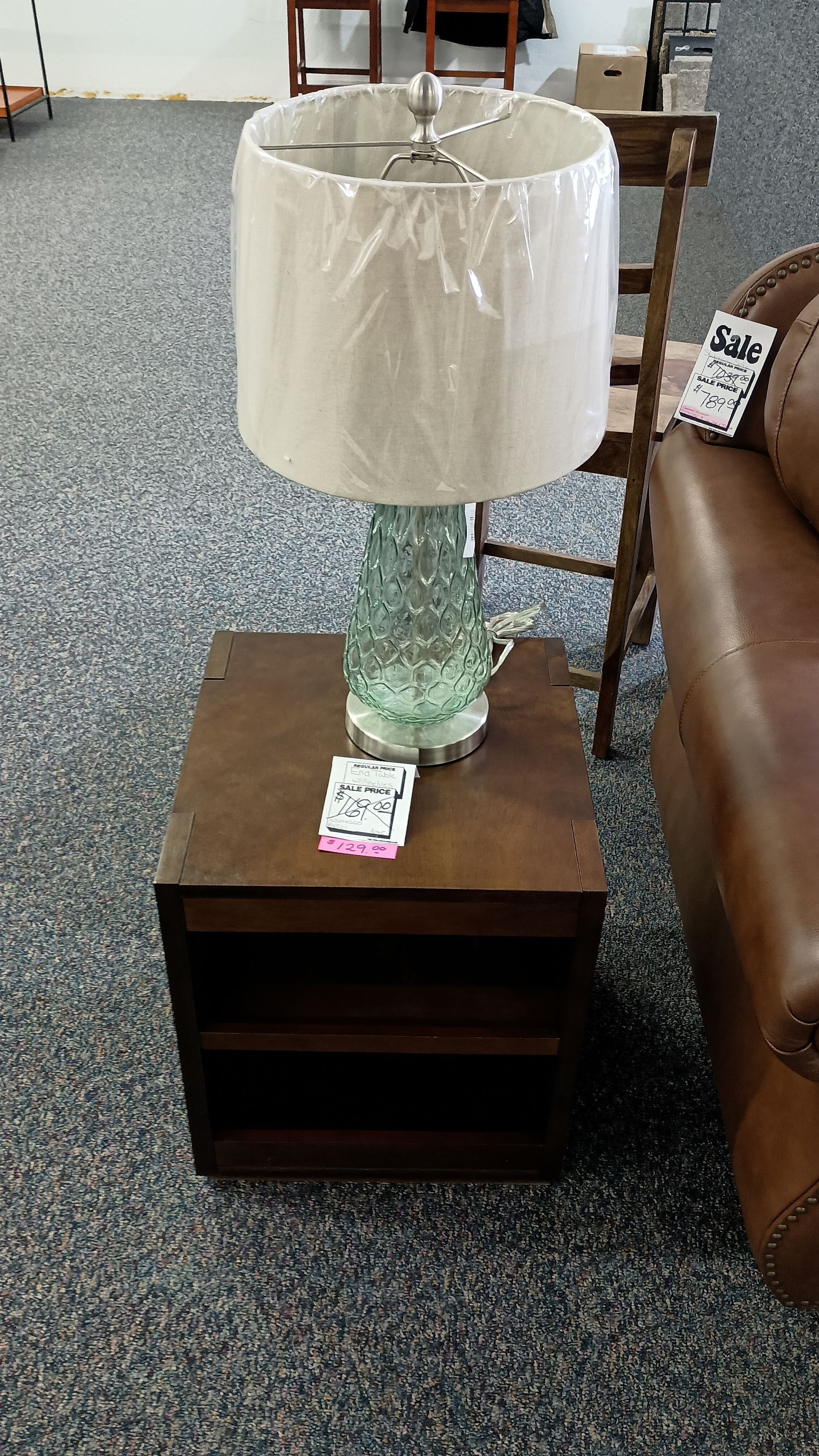 A lamp is sitting on a small wooden table in a living room