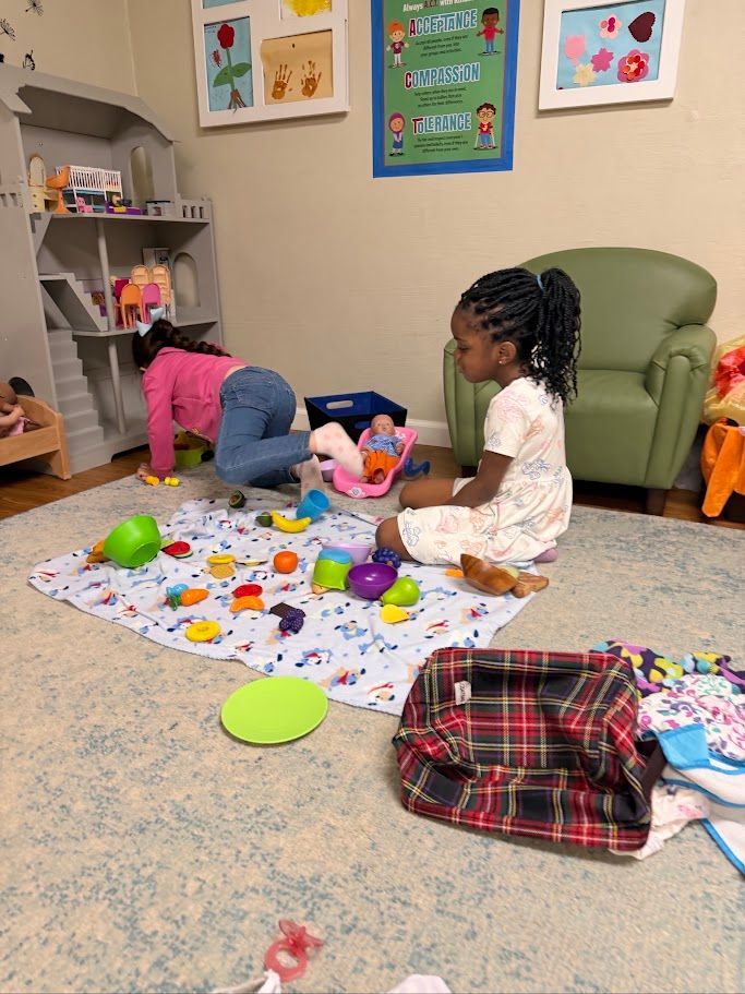 Two children playing with colorful toys on a rug in a playroom