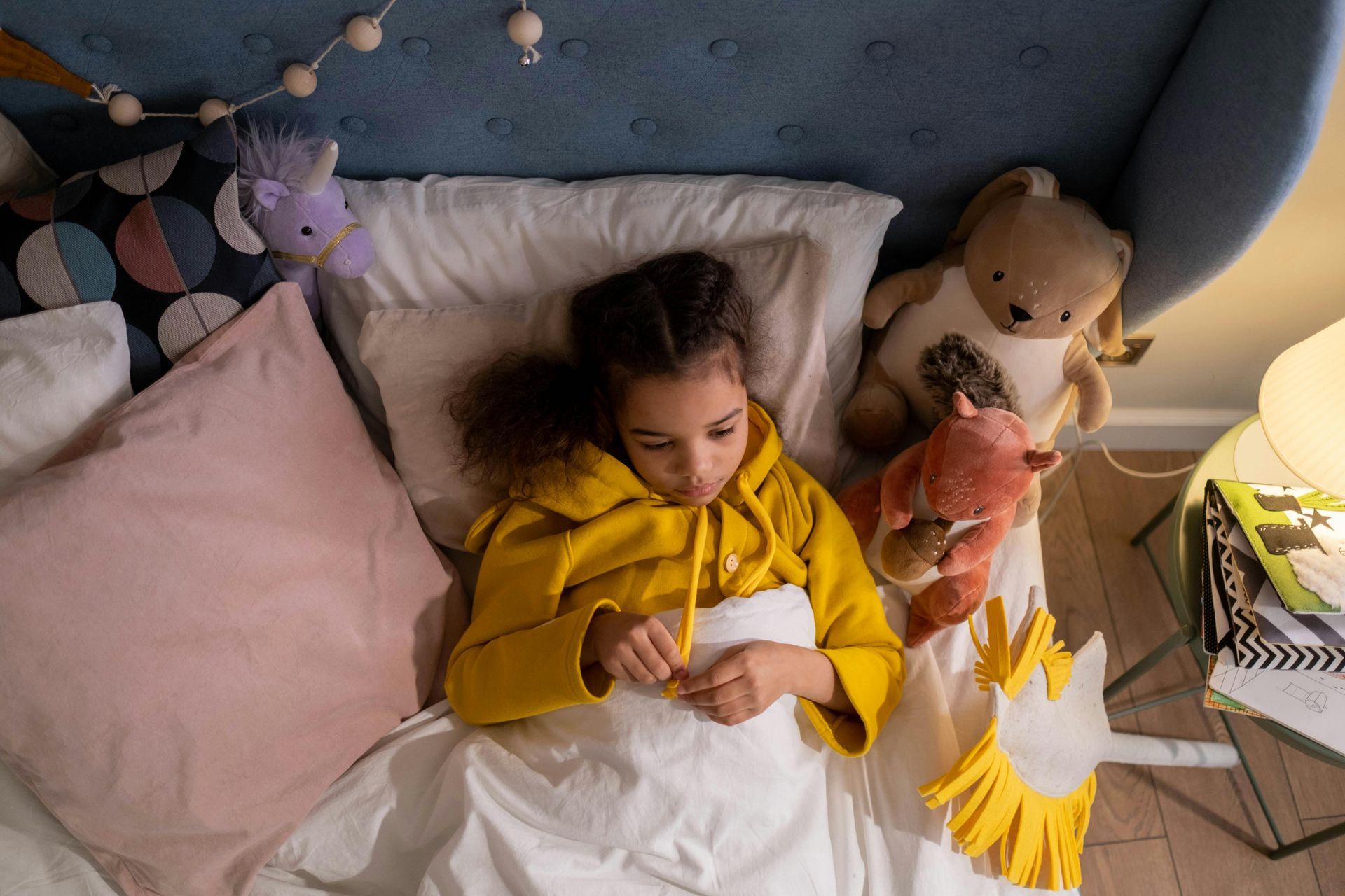 A sad young girl lying in her bed