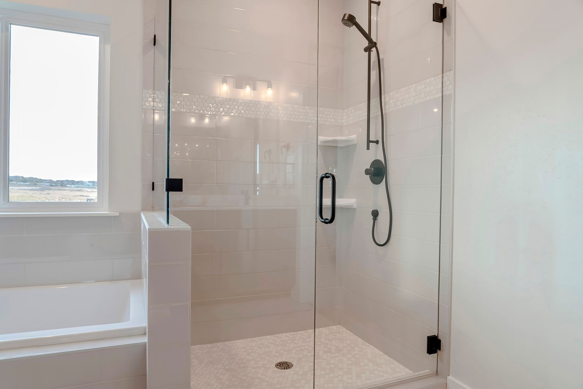 Modern white bathroom with a glass shower enclosure and built-in bathtub